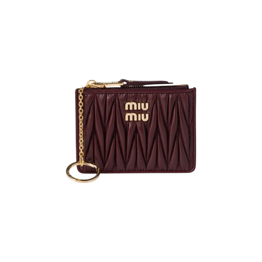 Via Manzoni Boutique burgundy quilted Matelassé leather Miu Miu card holder with gold logo and attached key ring.