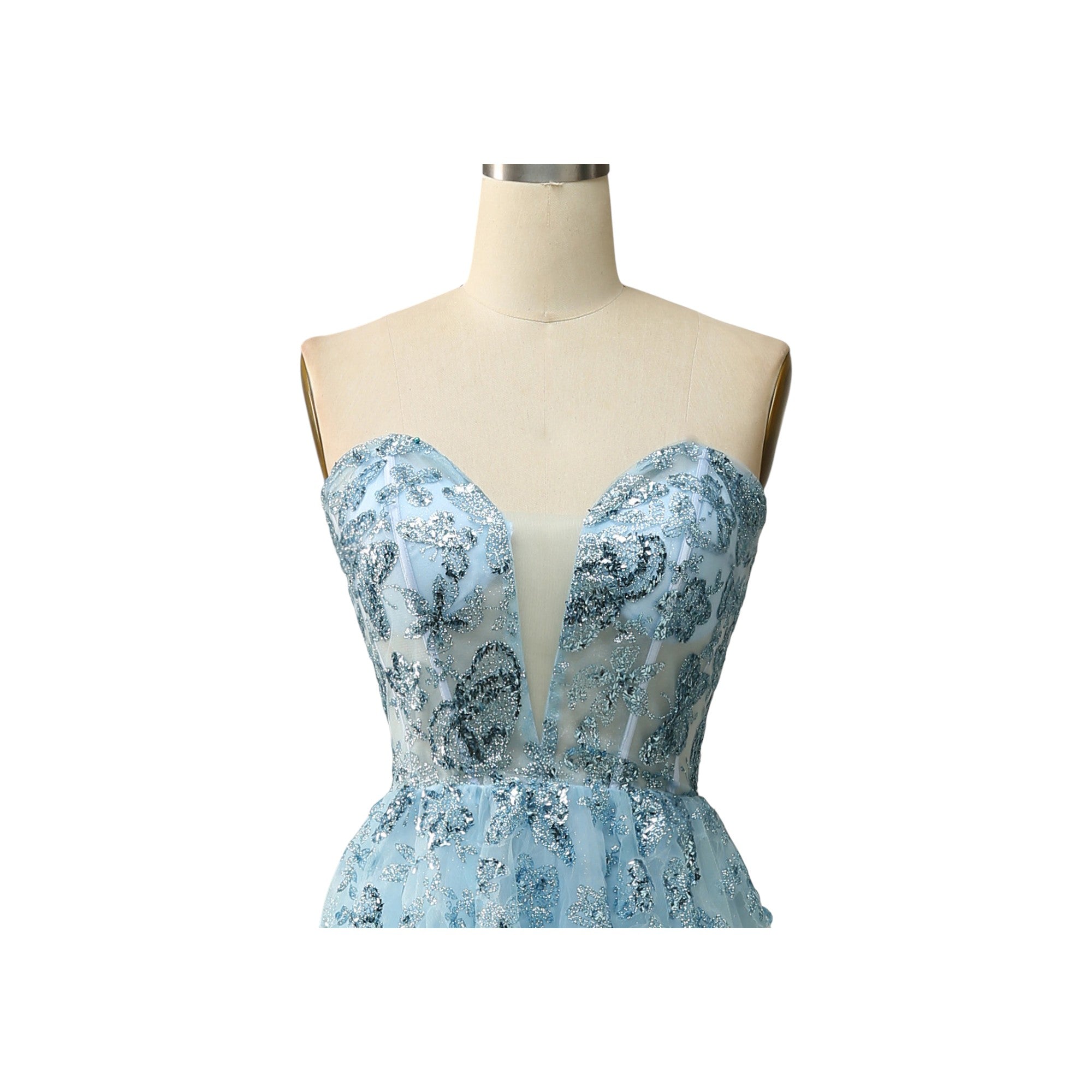 Via Manzoni Boutique dusty blue tulle prom dress with floral embroidery and V-neckline. Features spaghetti straps and corset back.