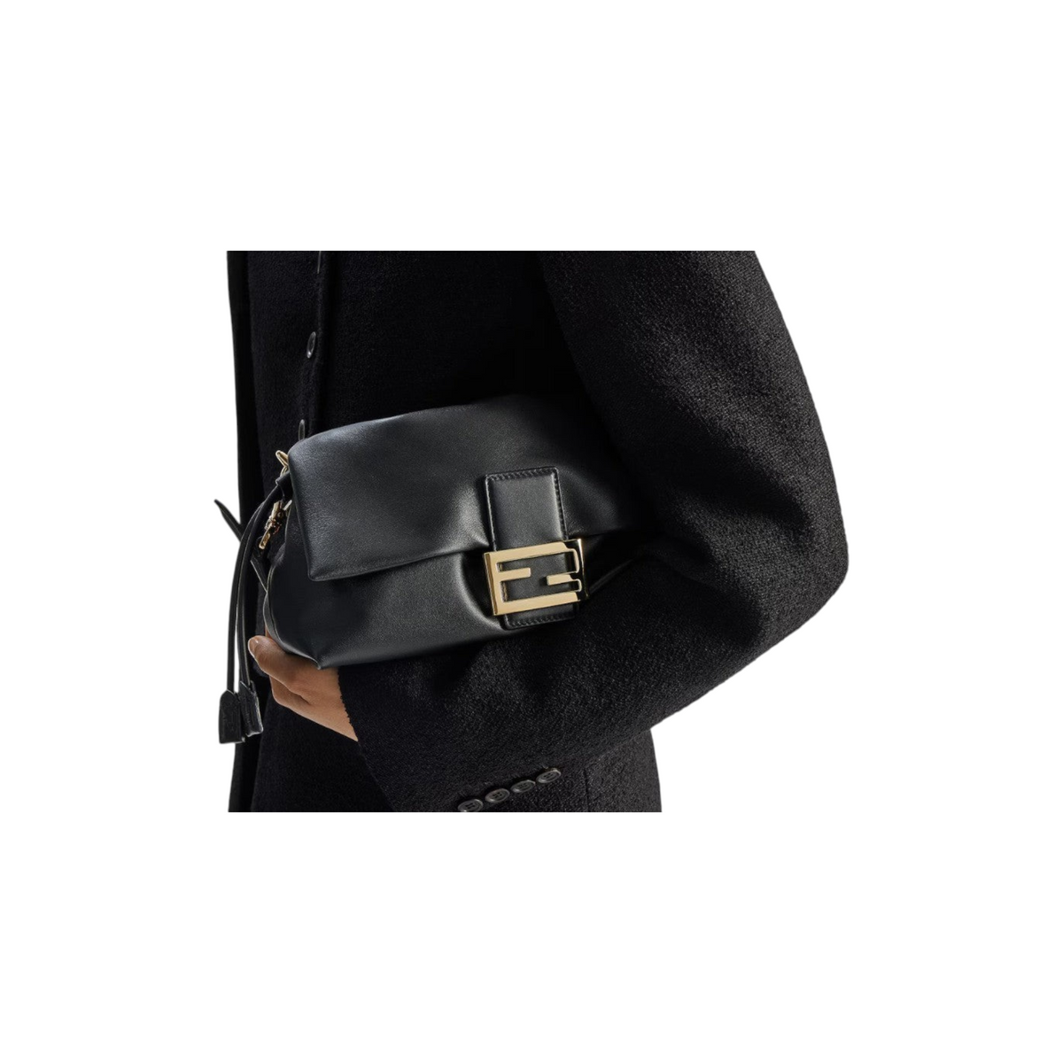 Via Manzoni Boutique black leather FENDI shoulder bag with gold-tone logo hardware held against a black coat