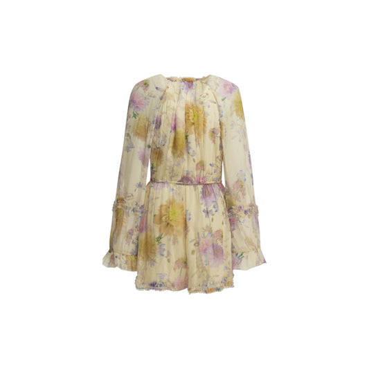Via Manzoni Boutique ivory chiffon mini dress with painterly floral print in lavender, lilac, yellow, and blush pink. Features ruffle trim, tie neck, pearlized buttons, and billowy sleeves.