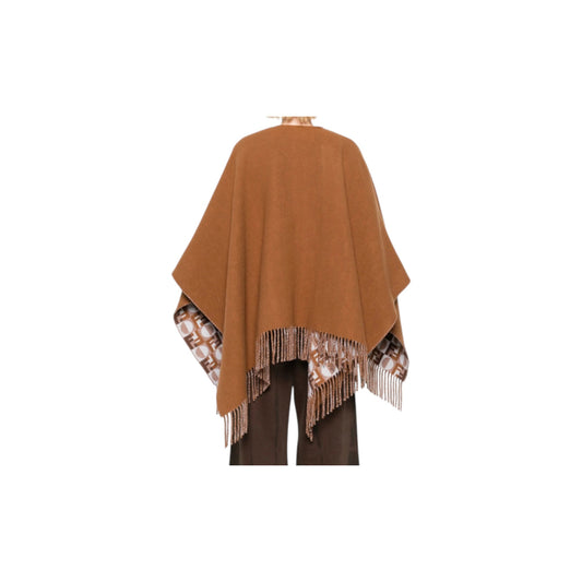 Via Manzoni Boutique reversible wool blend poncho in caramel with fringed edges and monogram print lining.