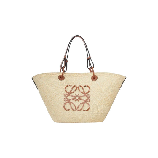 Via Manzoni Boutique natural raffia woven straw tote bag with tan leather straps and anagram logo.