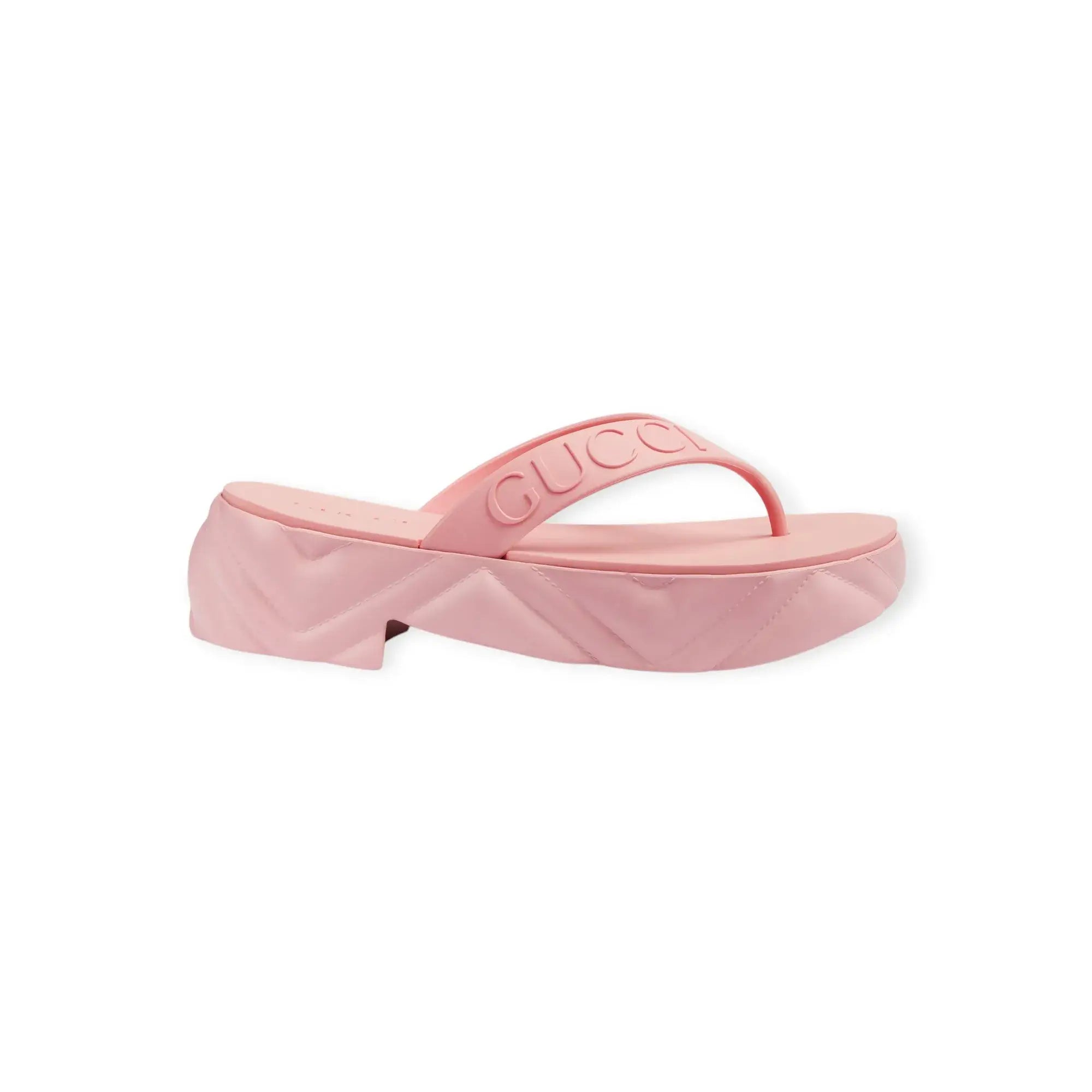 Women's pink Gucci thong platform sandal with embossed strap and rubber sole, retro-inspired design, made in Italy.