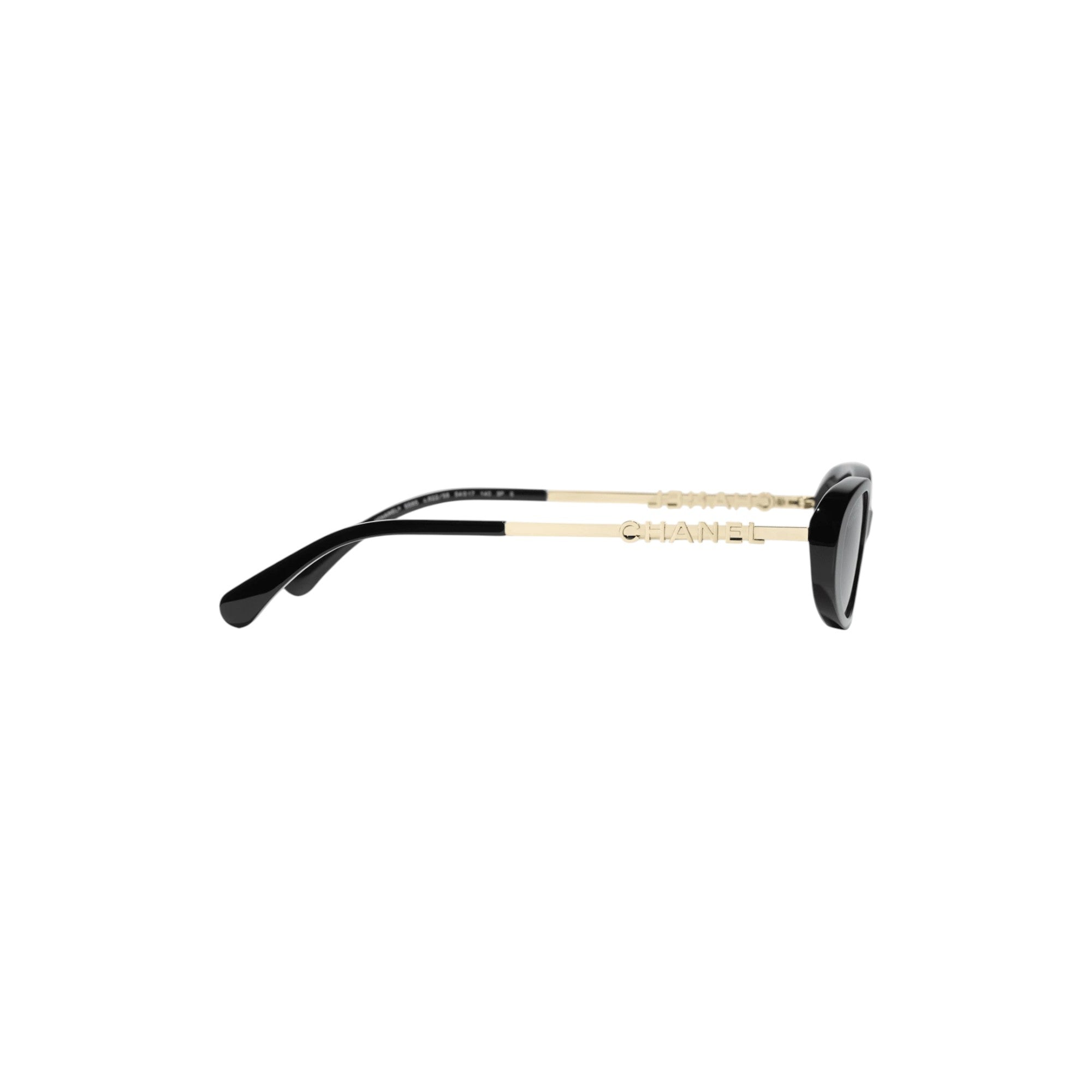 Via Manzoni Boutique Chanel black oval sunglasses with gold metal temples and signature lettering, side profile view.