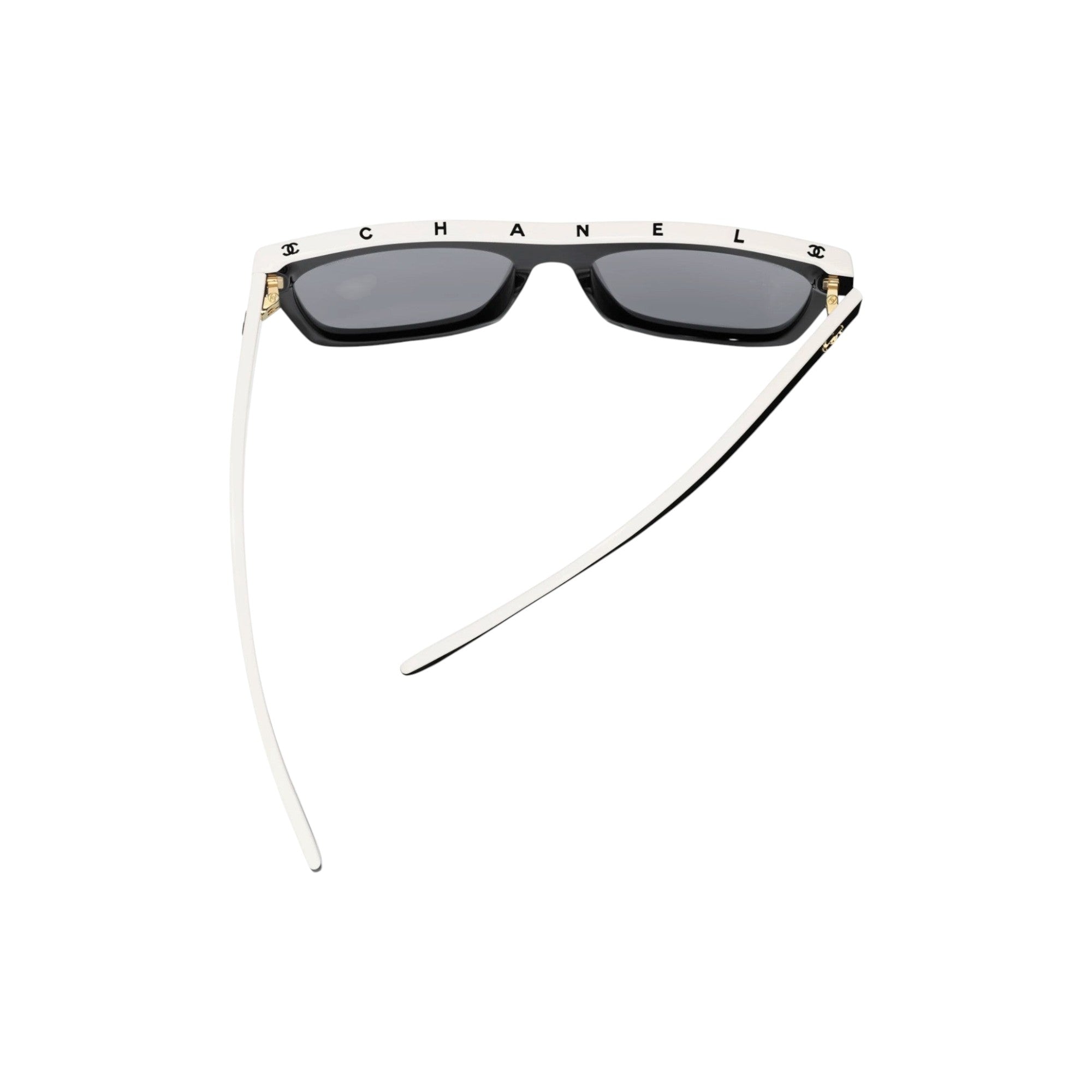 Via Manzoni Boutique Chanel black acetate rectangular sunglasses with white top rim and grey polarized lenses.