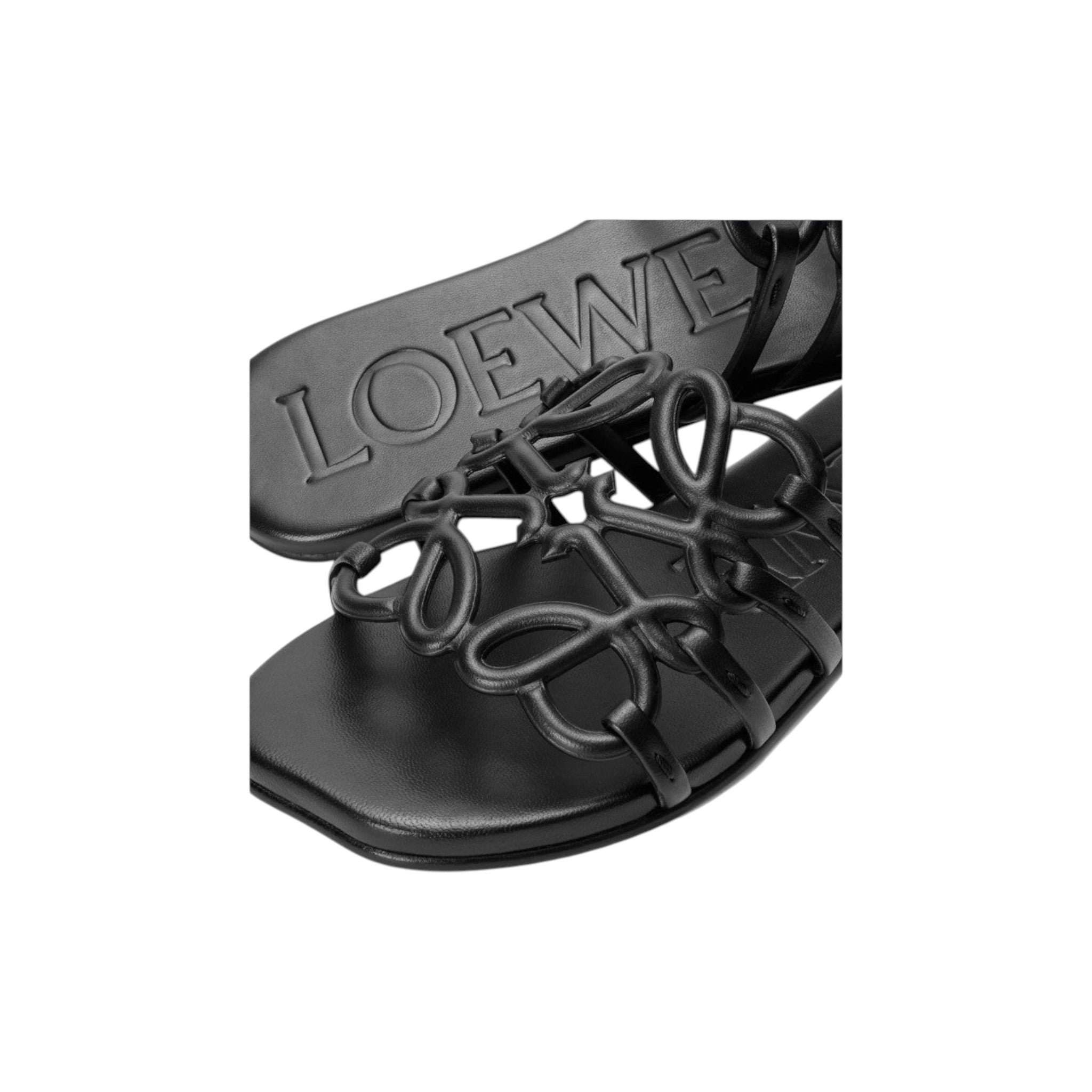 Via Manzoni Boutique black leather LOEWE slide sandals featuring an intricate knotted Anagram motif strap